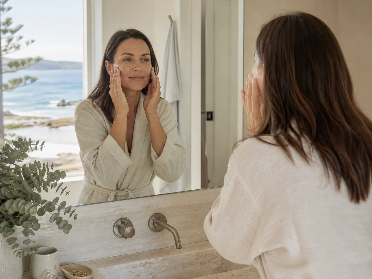 A woman beginning a self-care routine in natural Australian coastal light